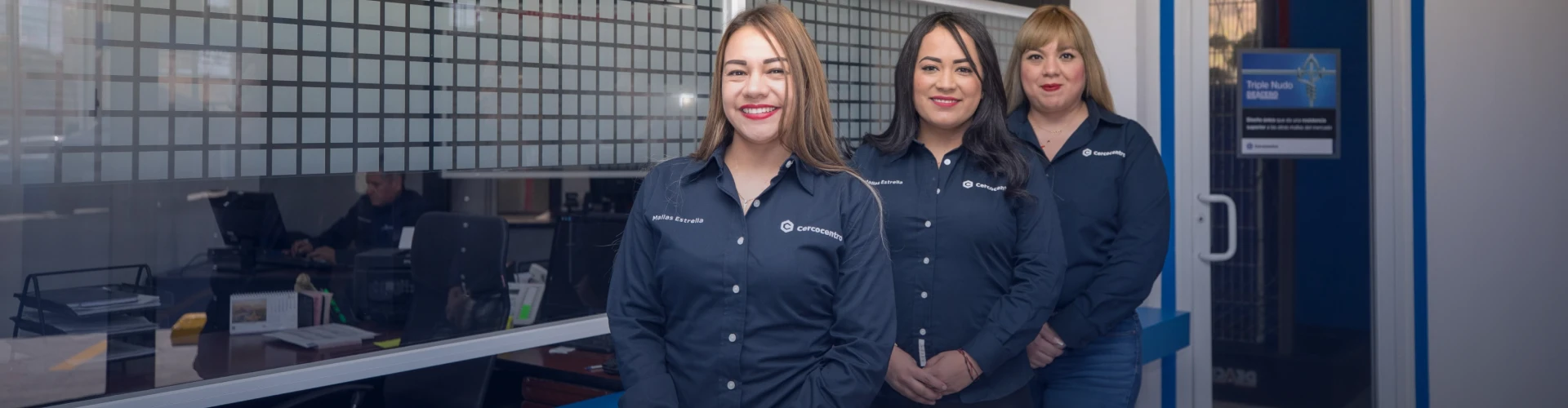 Tres mujeres con camisas de cercocentro en la recepción de una oficina