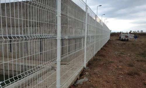 Reja Deacero Clásica blanca instalada a lo largo de un muro     con un vehículo a la distancia en El Picacho