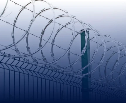 Complemento de alambre de puas encima de una reja